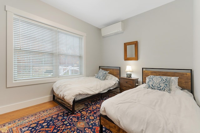 11 Beacon Dr, Brunswick, ME 04011 - bedroom featuring wood-type flooring and a wall mounted AC