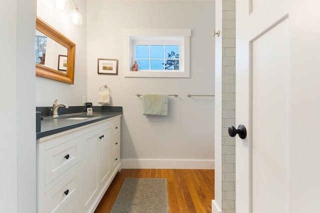 11 Beacon Dr, Brunswick, ME 04011 - bathroom featuring hardwood / wood-style floors, vanity, and a healthy amount of sunlight