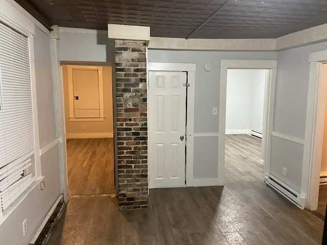 hallway featuring a baseboard radiator and dark hardwood / wood-style floors