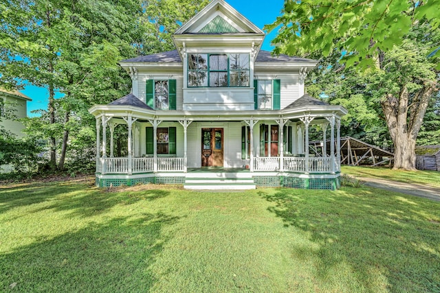 view of front of property with covered porch and a front yard