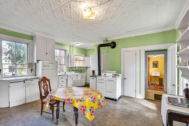 236 High St, Farmington, ME 04938 - kitchen featuring white appliances, concrete floors, ornamental molding, light countertops, and white cabinetry
