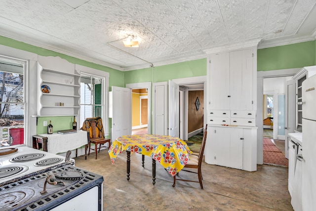 kitchen featuring white cabinets, electric range, concrete floors, and ornamental molding