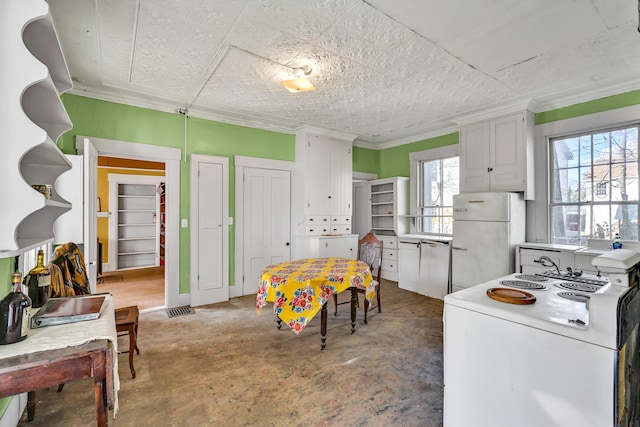 236 High St, Farmington, ME 04938 - kitchen featuring white appliances, white cabinetry, concrete flooring, ornamental molding, and light countertops