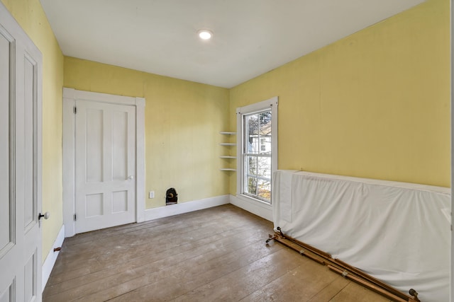 unfurnished room featuring hardwood / wood-style flooring