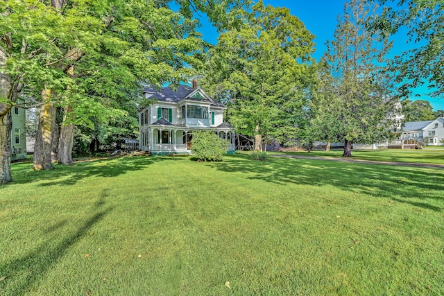 view of yard featuring covered porch