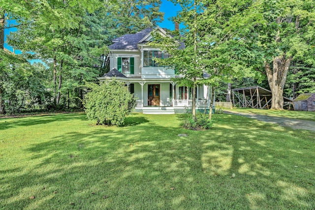 236 High St, Farmington, ME 04938 - victorian house featuring covered porch, a front lawn, and a shingled roof