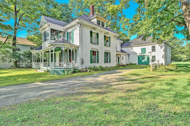 view of front of house featuring covered porch and a front yard