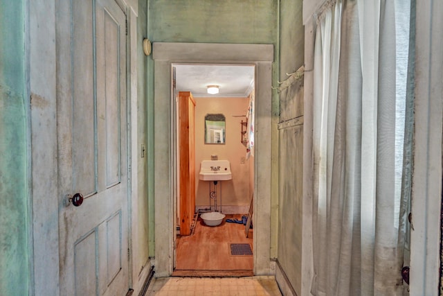 236 High St, Farmington, ME 04938 - hallway with light flooring, ornamental molding, and a sink