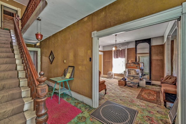 236 High St, Farmington, ME 04938 - living room featuring stairway, baseboards, and a chandelier