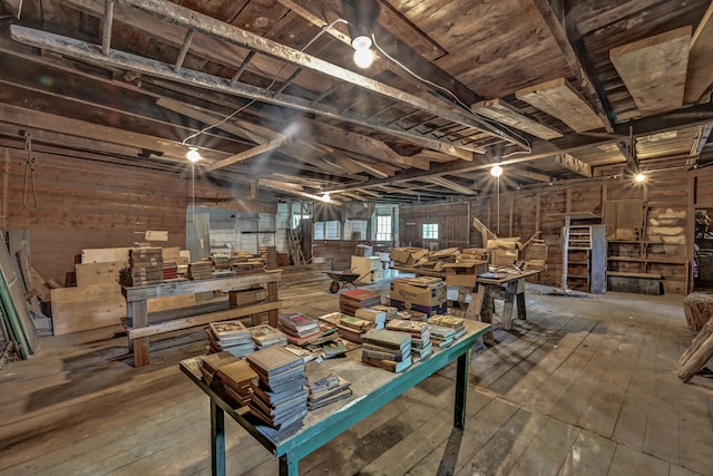 misc room featuring lofted ceiling with beams, wood walls, wood ceiling, and hardwood / wood-style flooring