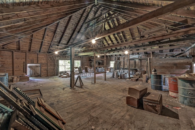 miscellaneous room featuring hardwood / wood-style floors, vaulted ceiling with beams, wooden ceiling, and wooden walls