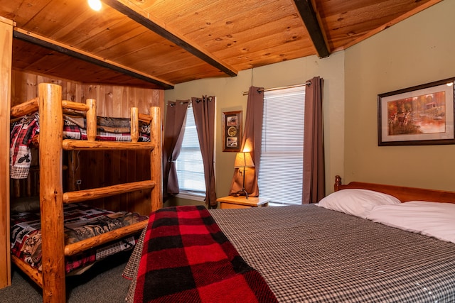 bedroom with carpet floors, beamed ceiling, and wooden ceiling