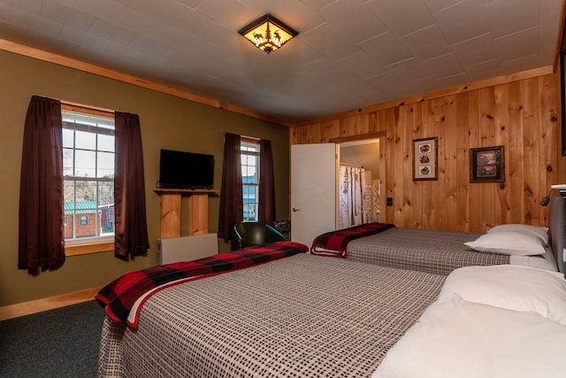 carpeted bedroom with wooden walls