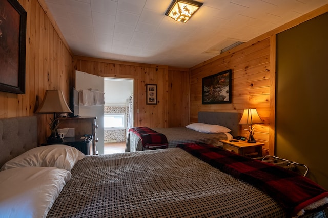 bedroom featuring wooden walls