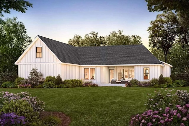 back house at dusk with a yard