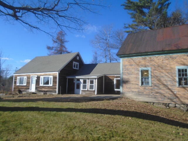 rear view of house with a yard