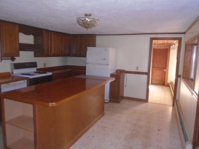 kitchen with white appliances, baseboard heating, and light carpet