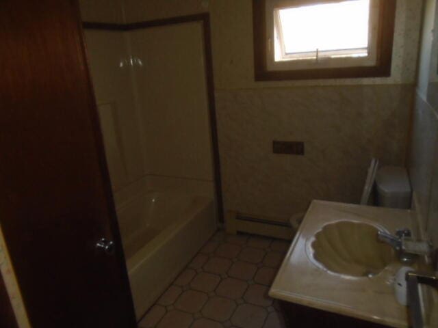 full bathroom featuring vanity, toilet, shower / bath combination, and baseboard heating