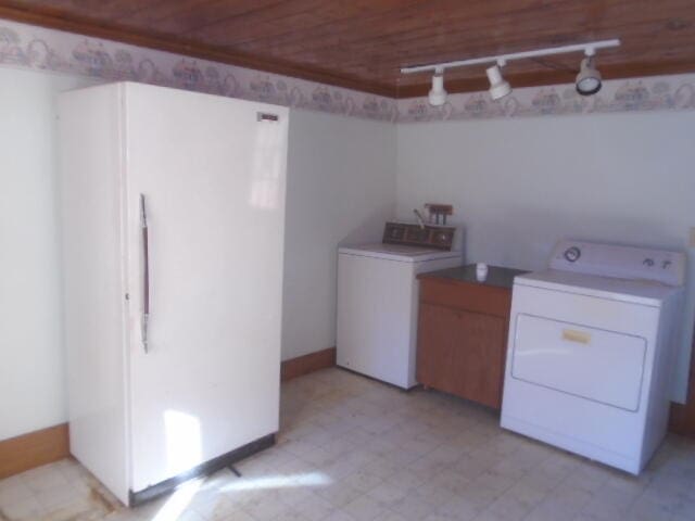 clothes washing area featuring washing machine and dryer and wooden ceiling