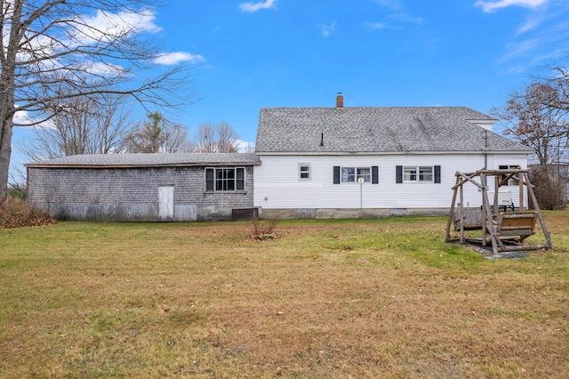 back of property with a lawn