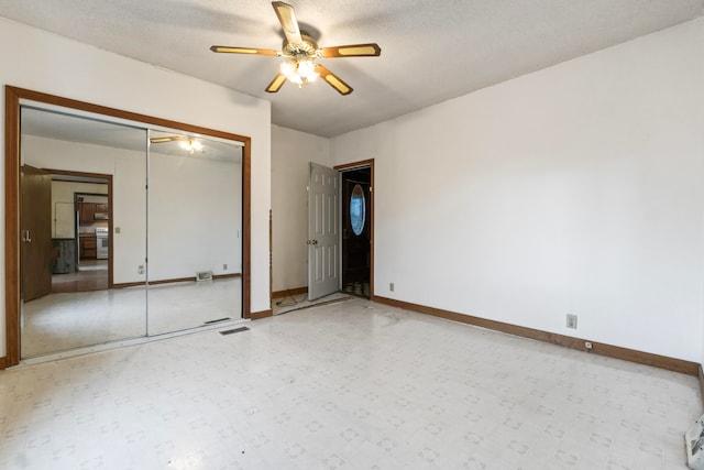 unfurnished bedroom with ceiling fan, a closet, and a textured ceiling