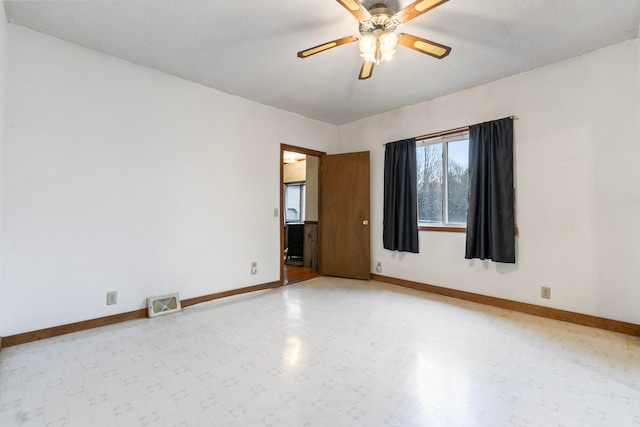 empty room featuring ceiling fan and a textured ceiling