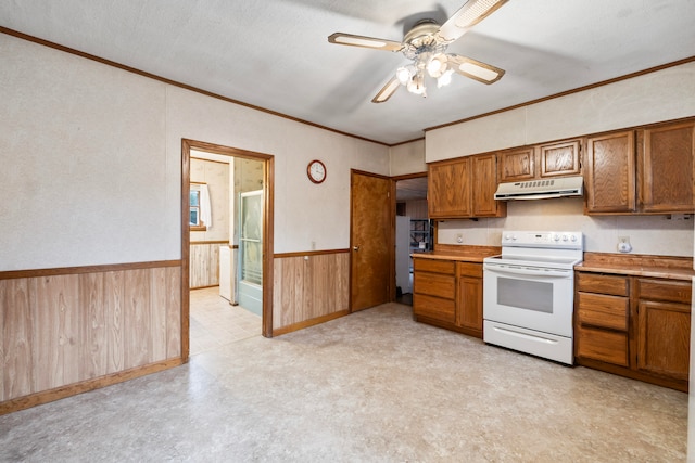 kitchen featuring ceiling fan, electric stove, ornamental molding, and wooden walls