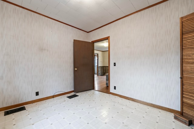 unfurnished room featuring crown molding