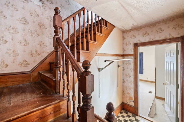 stairway with a textured ceiling