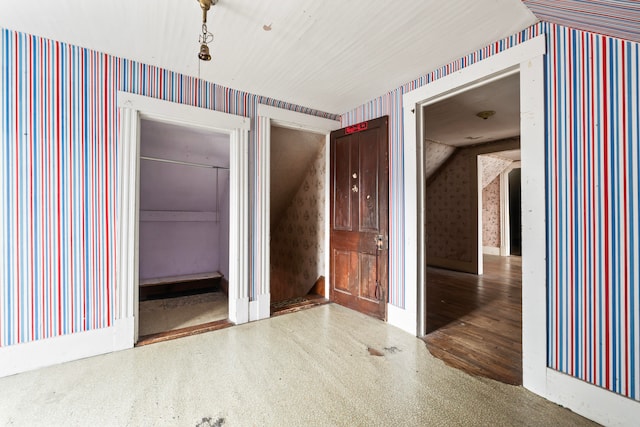 unfurnished room featuring hardwood / wood-style floors and lofted ceiling