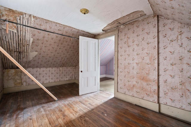 additional living space featuring hardwood / wood-style flooring and lofted ceiling