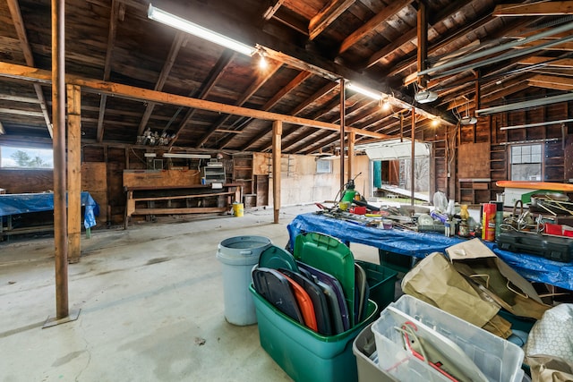 misc room featuring concrete flooring and vaulted ceiling