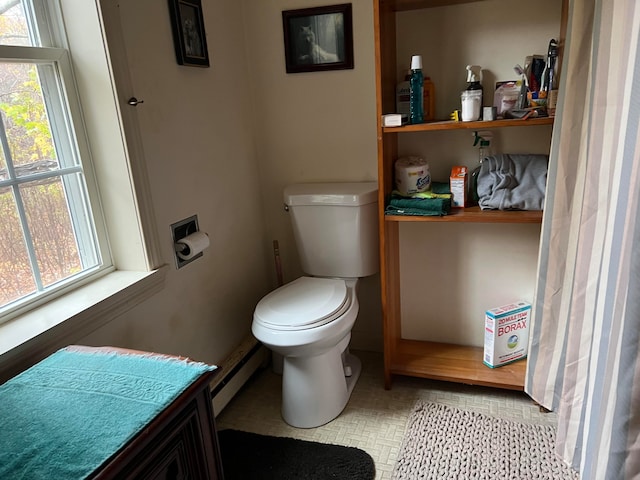 bathroom with toilet and baseboard heating