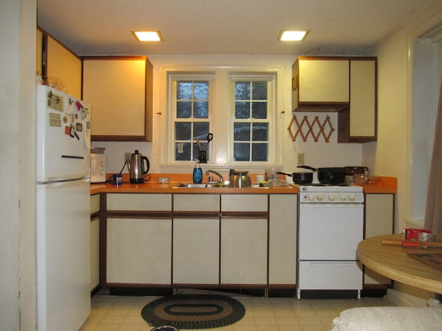 kitchen featuring sink and white appliances