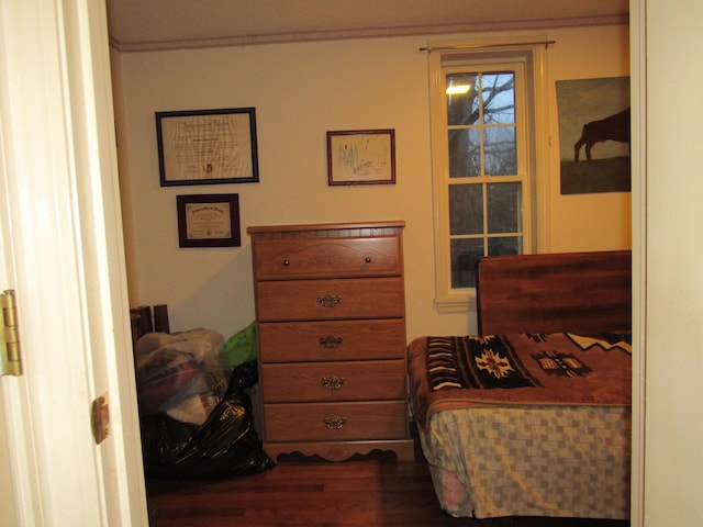 bedroom featuring dark hardwood / wood-style flooring and ornamental molding