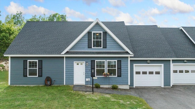 view of front of home featuring a front yard and a garage