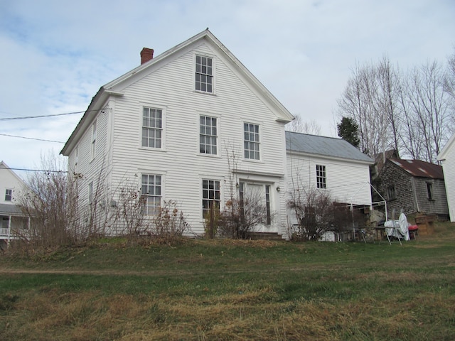 rear view of property with a yard