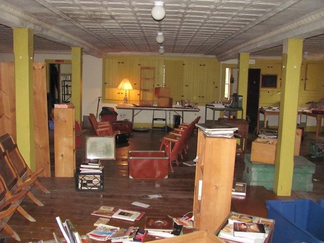 dining room featuring wood walls and dark hardwood / wood-style flooring