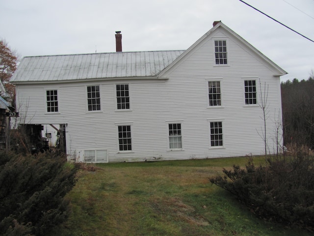 rear view of house with a lawn