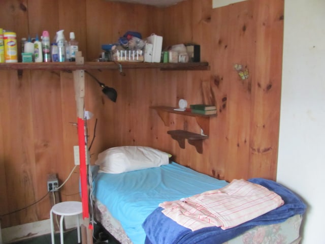 bedroom with wooden walls