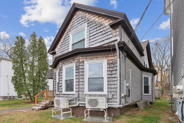 exterior space with a yard and ac unit