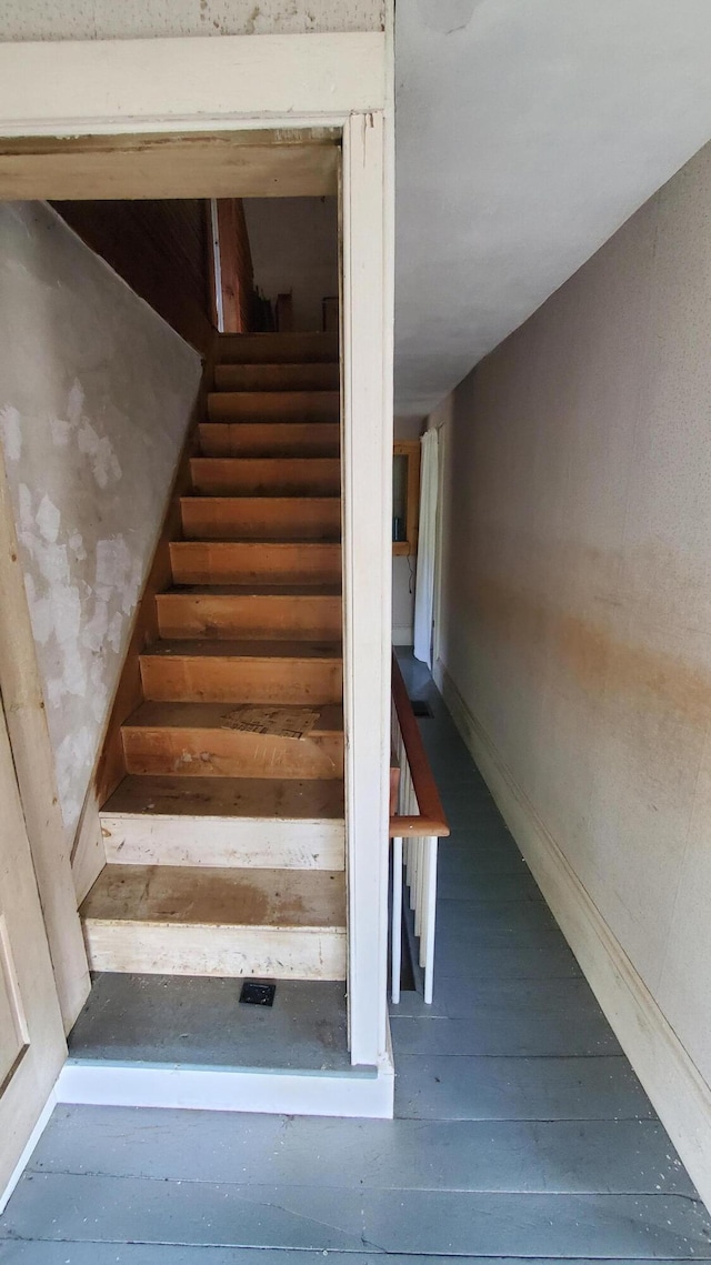 staircase with wood-type flooring