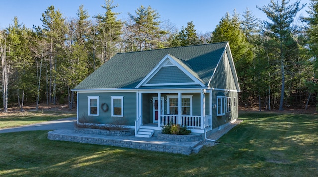 view of front of house with covered porch and a front lawn