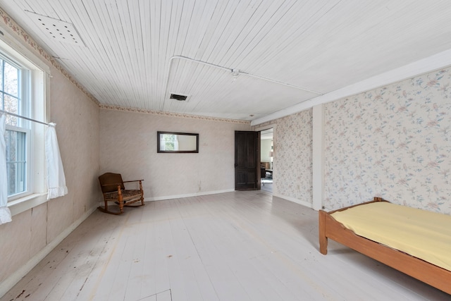 unfurnished room with wood ceiling and hardwood / wood-style flooring