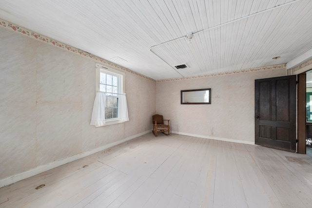 unfurnished room with wood ceiling and wood-type flooring