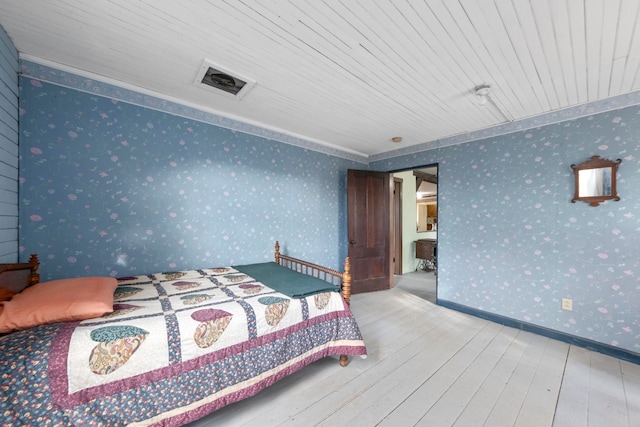 bedroom with wooden ceiling and light wood-type flooring