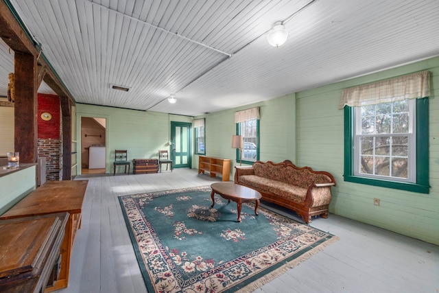 living room with wooden walls and hardwood / wood-style flooring