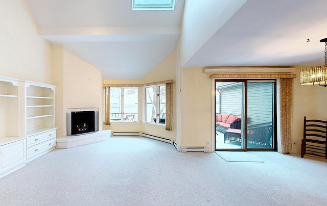 9 Jameson Point Rd Unit 10, Rockland, ME 04841 - unfurnished living room featuring carpet flooring, a chandelier, a warm lit fireplace, plenty of natural light, and high vaulted ceiling