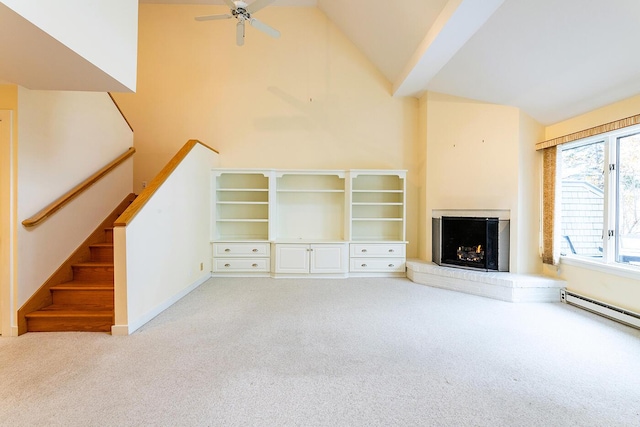 9 Jameson Point Rd Unit 10, Rockland, ME 04841 - unfurnished living room featuring carpet floors, a fireplace with raised hearth, ceiling fan, stairway, and high vaulted ceiling