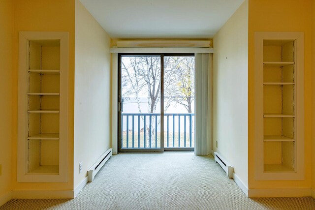 9 Jameson Point Rd Unit 10, Rockland, ME 04841 - unfurnished bedroom featuring a baseboard heating unit, carpet floors, a baseboard radiator, and access to outside